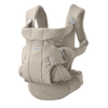 A Baby Bjorn front-facing baby carrier in a light beige fabric, shown against a solid white background.