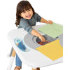 Child playing at a colorful children's activity table with crayons and paper.